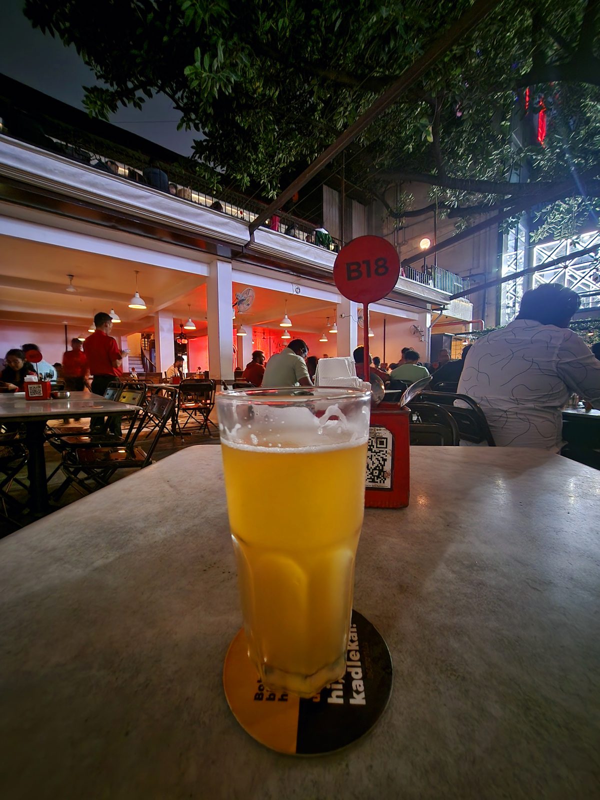 A glass of fresh beer at an open-air Bengaluru bar in the evening