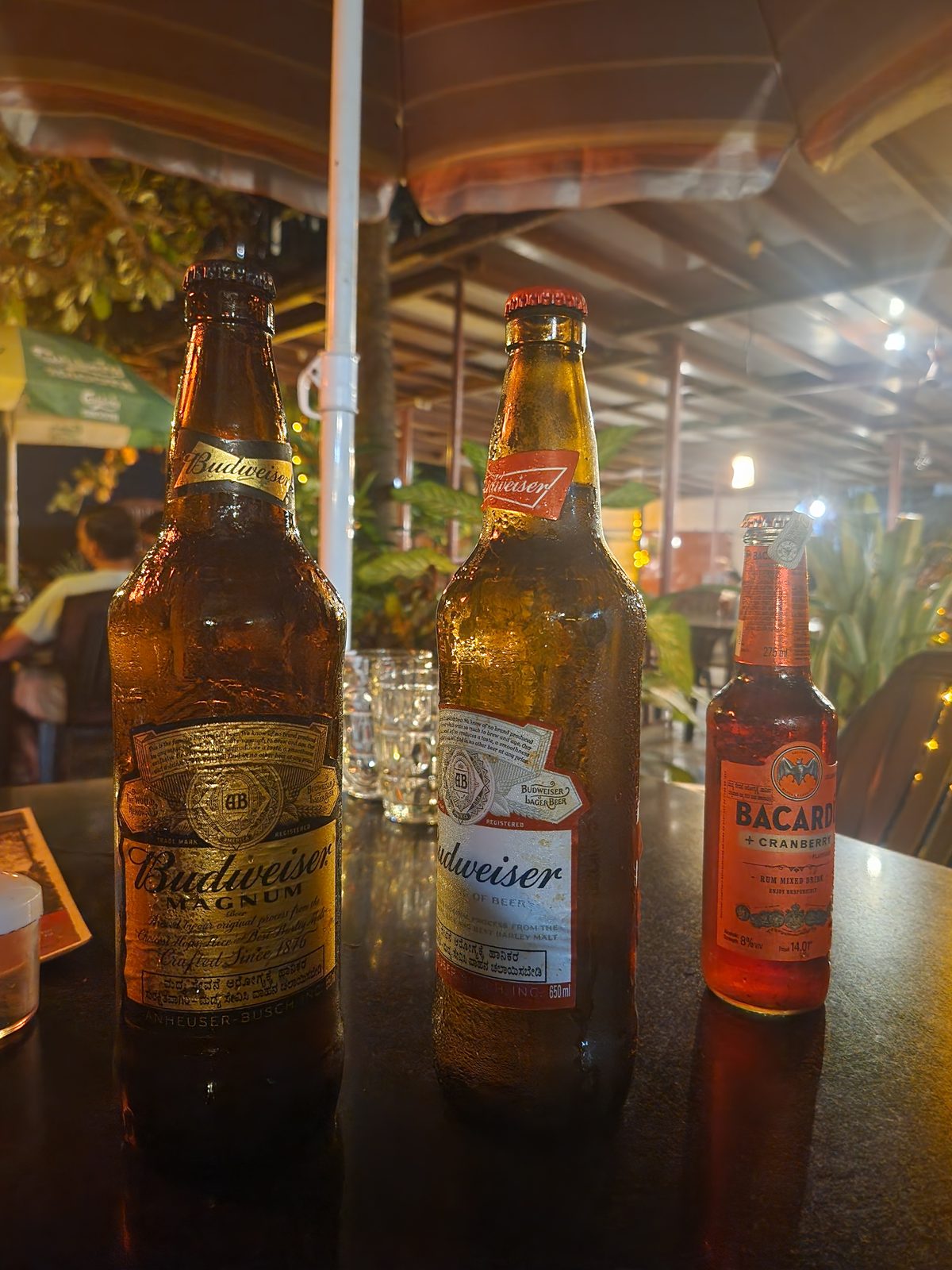 Two cold beers on a table at a beach shack in Gokarna at dusk