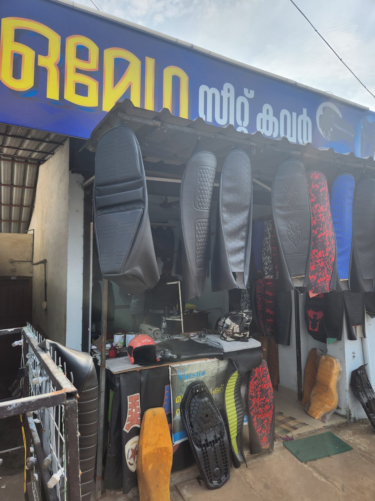 A roadside upholstery shop with foam and cushions on display