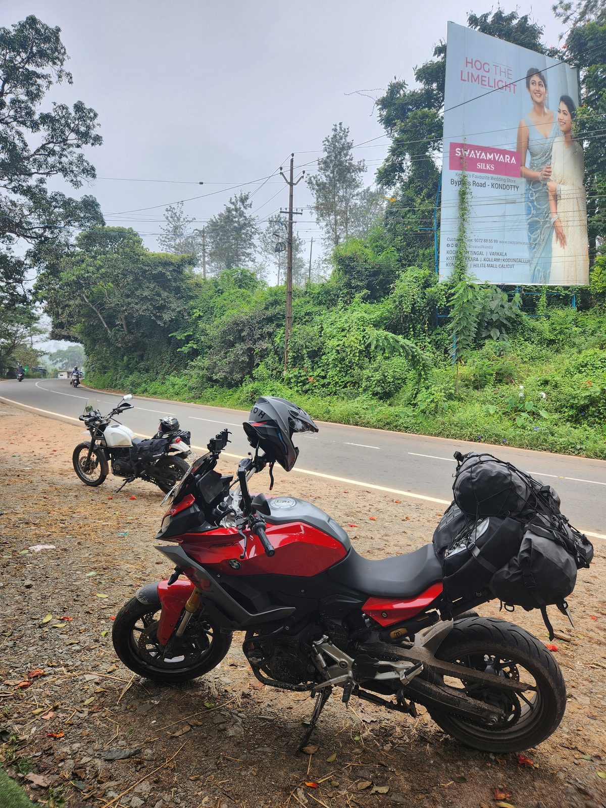 The motorcycle parked among green hills in Wayanad