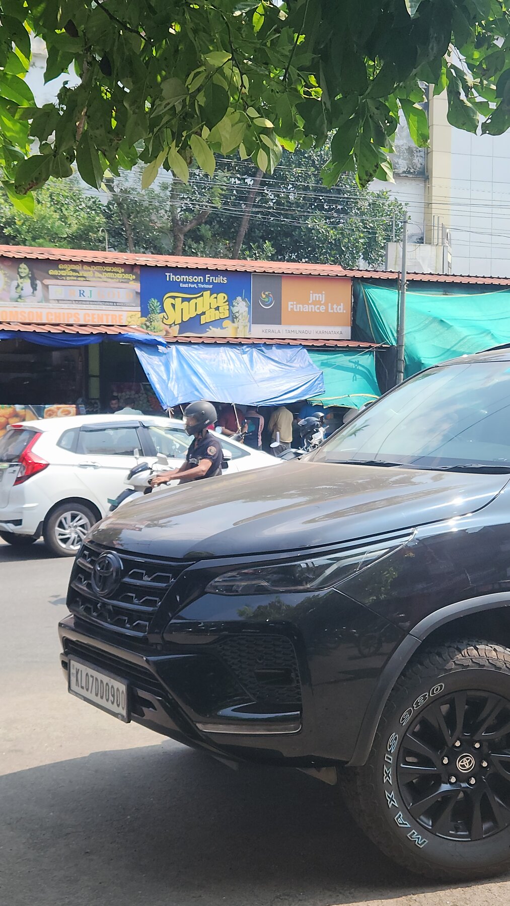 Thomson Fruits shop frontage near East Fort Thrissur with the Fortuner parked outside