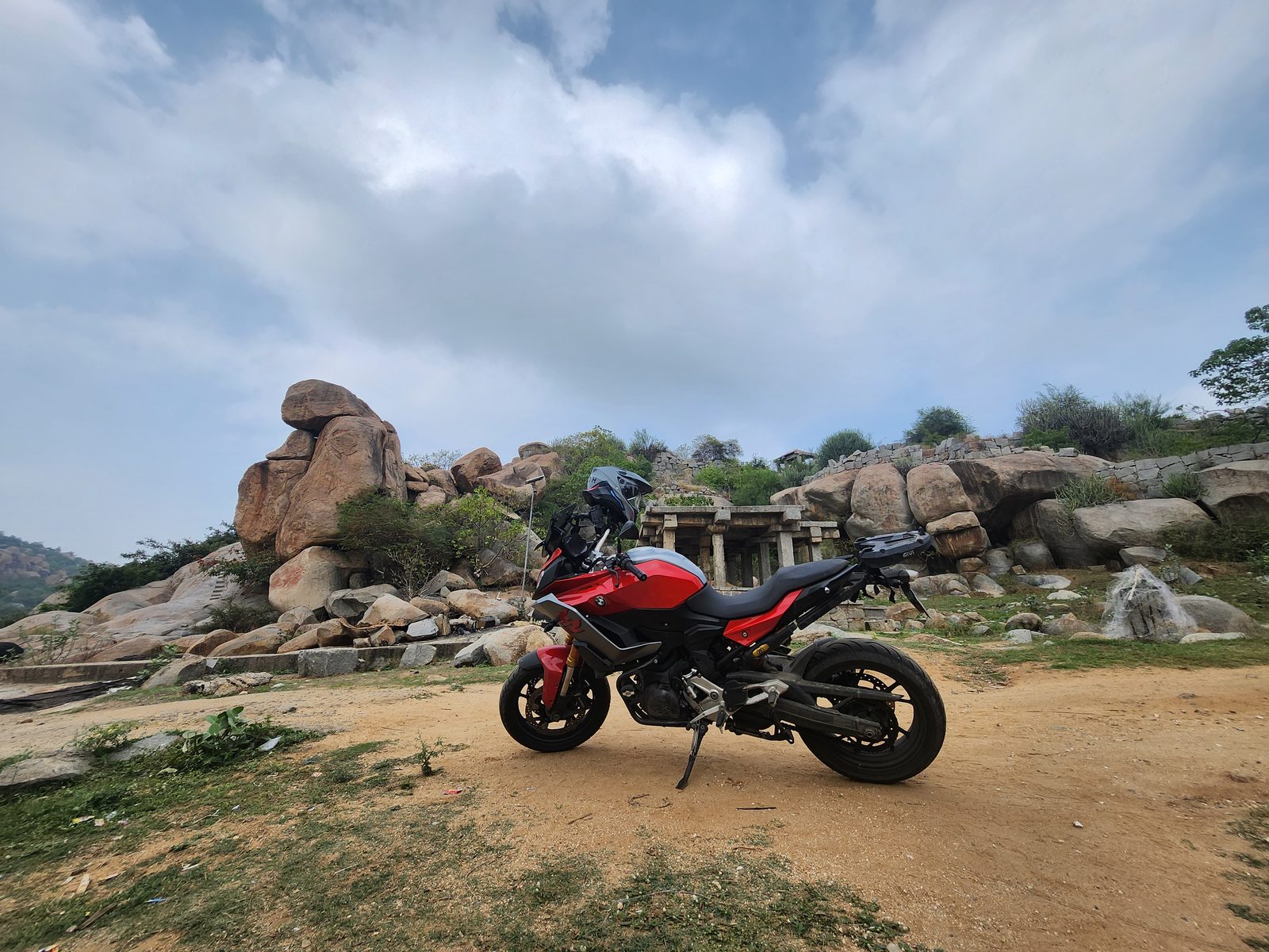 The bike parked among Hampi's boulders and ruins