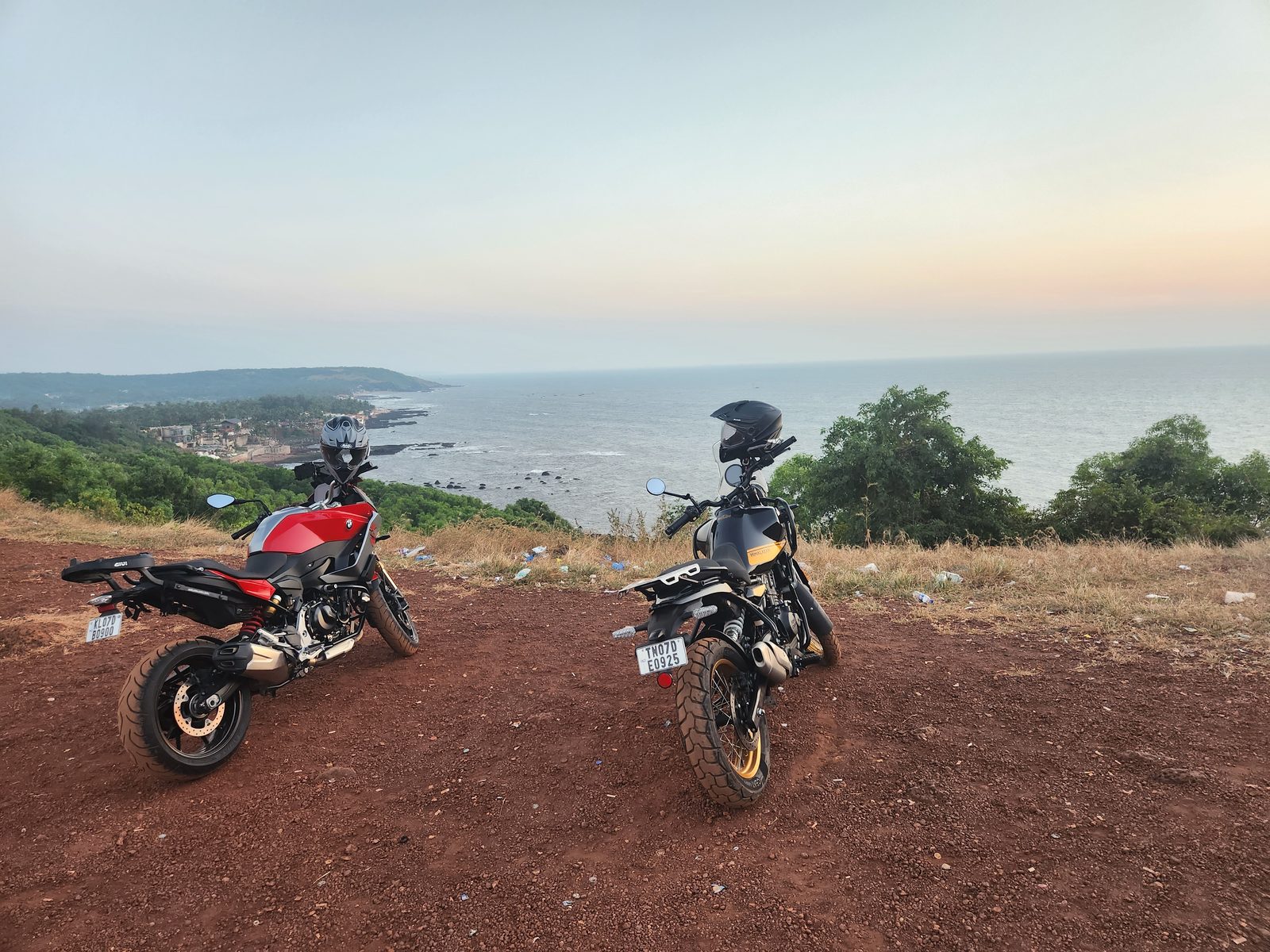 Two motorcycles on a hilltop above the sea at sunset, Vagator