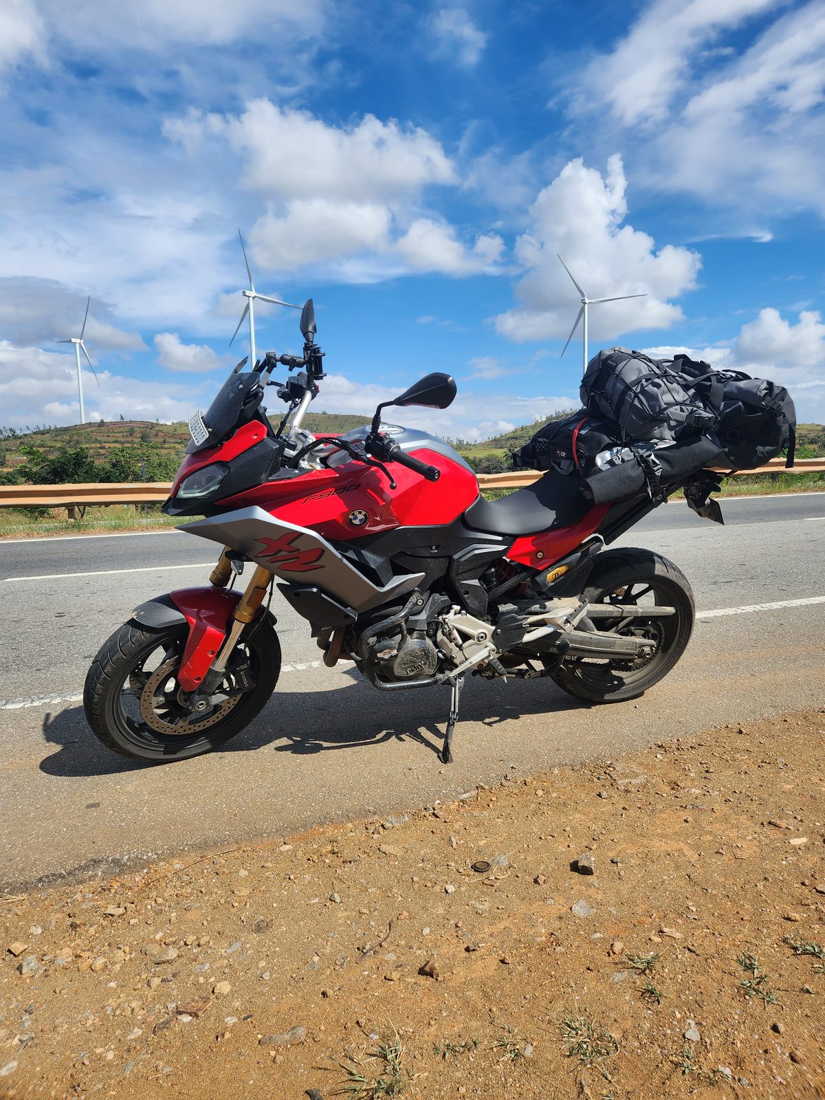 The F900XR parked on the roadside with wind turbines behind